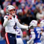 New England Patriots quarterback Bailey Zappe (4) reacts to throwing his first interception of the first half at Highmark Stadium.