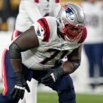 New England Patriots guard Mike Onwenu (71) lines up during the first half of an NFL football game against the Pittsburgh Steelers in Pittsburgh, Thursday, Dec. 7, 2023.