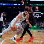 Celtics forward Jayson Tatum drives to the basket past Detroit Pistons guard Jaden Ivey, rear, during the second half.