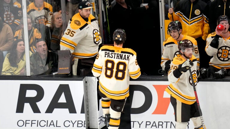 Boston Bruins right wing David Pastrnak (88) leaves the game after being charged with a game misconduct after boarding New York Rangers' Ryan Lindgren during the second period of an NHL hockey game, Saturday, Dec. 16, 2023, in Boston.