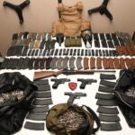 Seized weapons, ammunition and high capacity magazines, found following a high speed pursuit and are displayed in East Providence.
