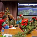 This image provided by the Department of Defense shows volunteers answering phones and emails from children around the globe during the annual NORAD Tracks Santa event on Peterson Air Force Base in Colorado Springs, Colo., Dec. 24, 2021.