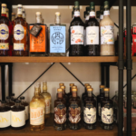 Shelves containing multiple bottles of non-alcoholic liquor.