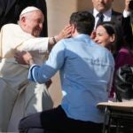 Newlyweds meet with Pope Francis in St. Peter's Square at the Vatican.