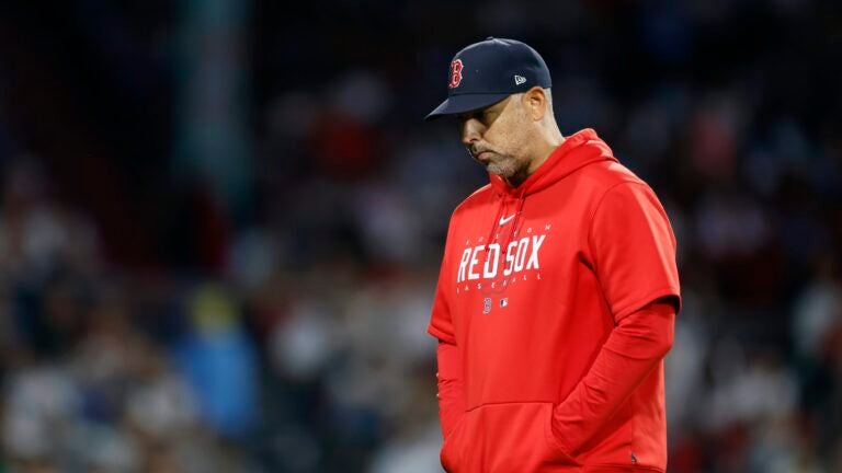 Boston Red Sox manager Alex Cora walks to the dug out after conferring on the mound in the fifth inning during the second game of a baseball doubleheader against the New York Yankees in Boston, Thursday, Sept. 14, 2023.