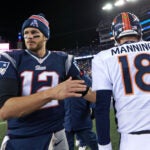 As the final 15 seconds tick off the clock, Broncos quarterback Peyton Manning (left) and Tom Brady (right) meet quickly, shook hands even quicker and then they seperated. The New England Patriots hosted the Denver Broncos in a regular season NFL game at Gillete Stadium.