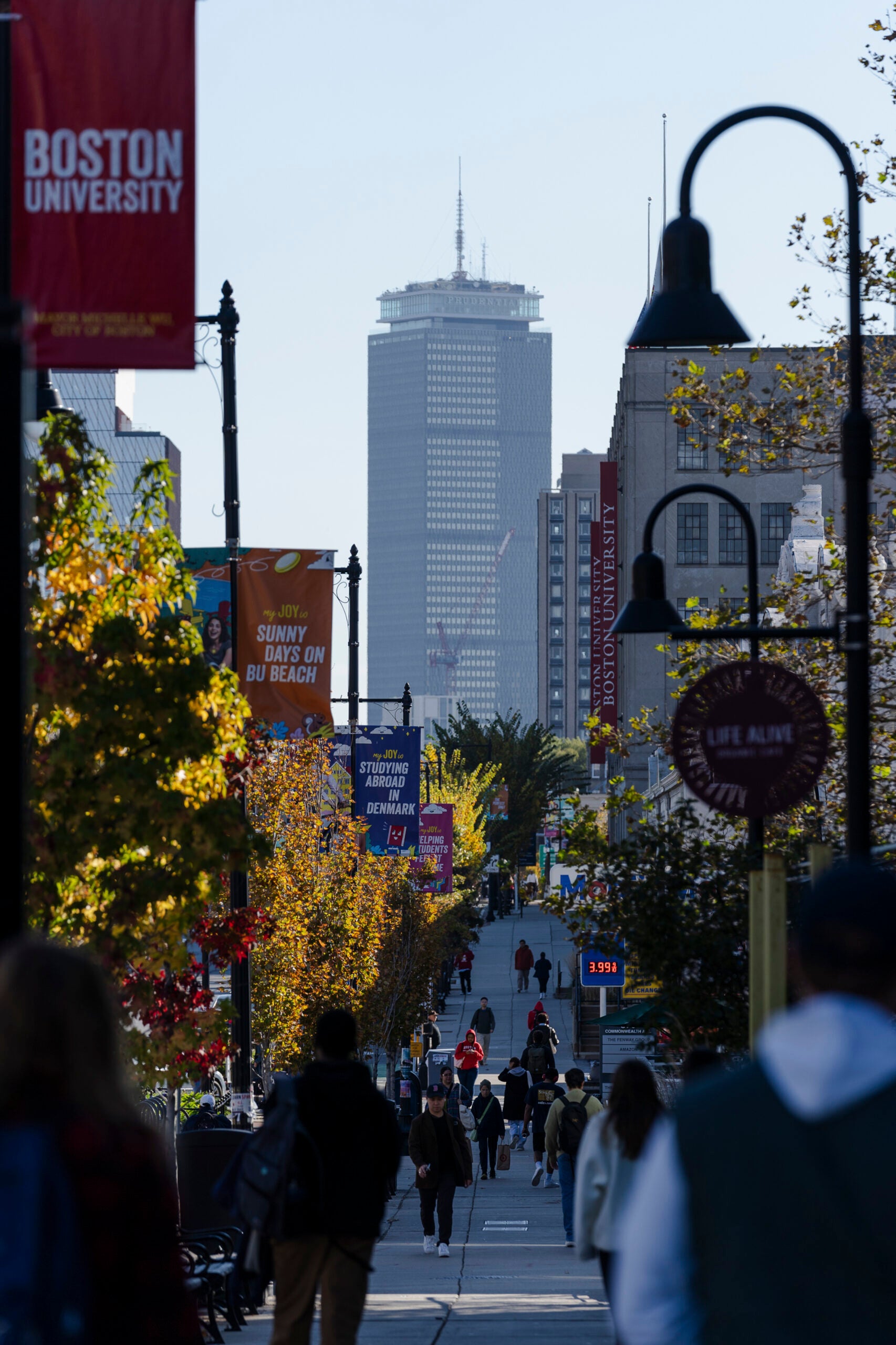 People walk through Boston University’s West Campus in Boston.