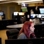 Dispatchers take calls at the Hamilton County 911 Communications Center in Indianapolis.