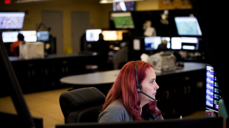 Dispatchers take calls at the Hamilton County 911 Communications Center in Indianapolis.