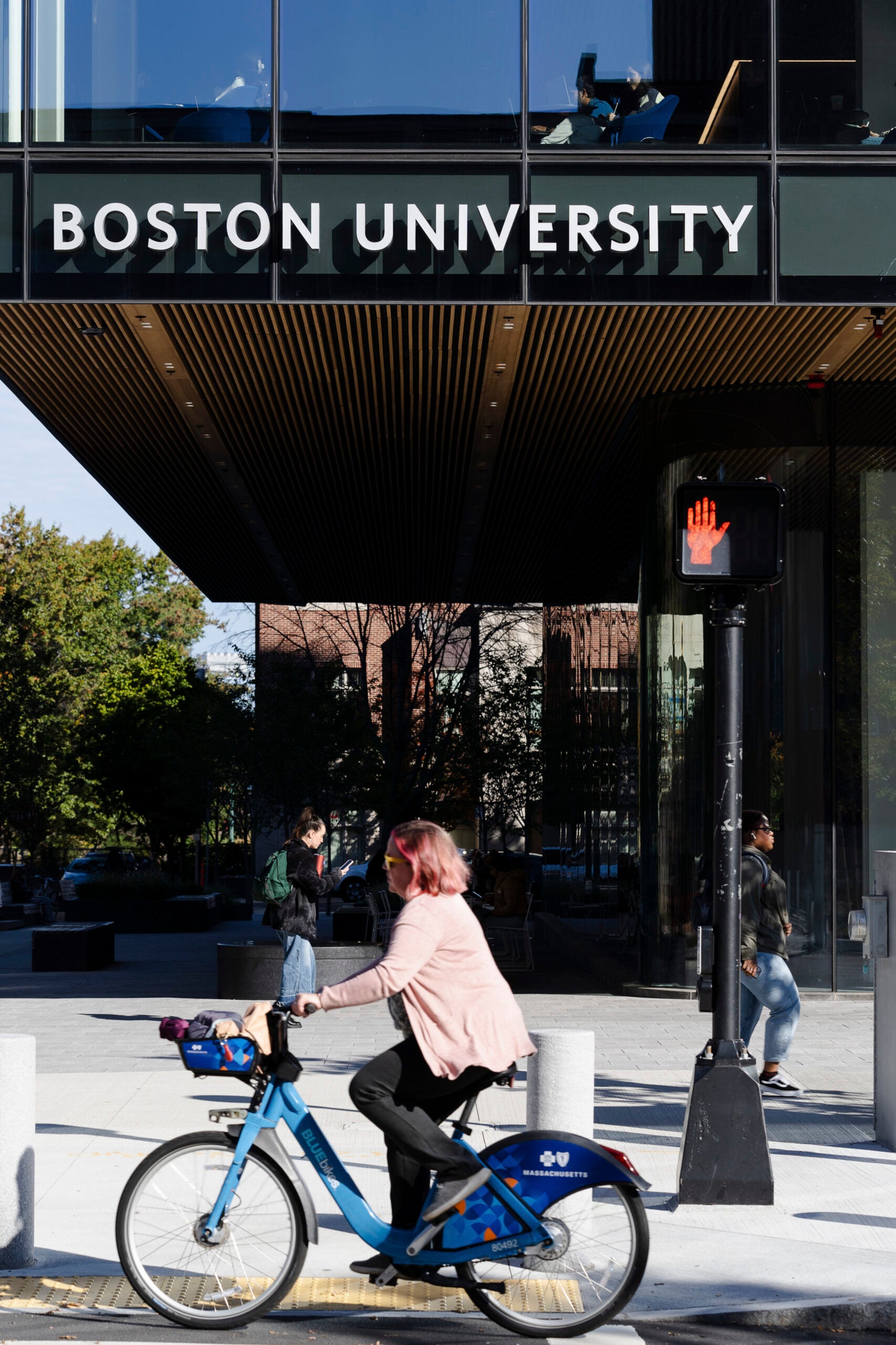 People walk through Boston University’s East Campus in Boston.