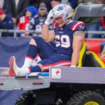 New England Patriots Cole Strange is carted off the field with an injury against the Kansas City Chiefs during second quarter NFL action at Gillette Stadium.