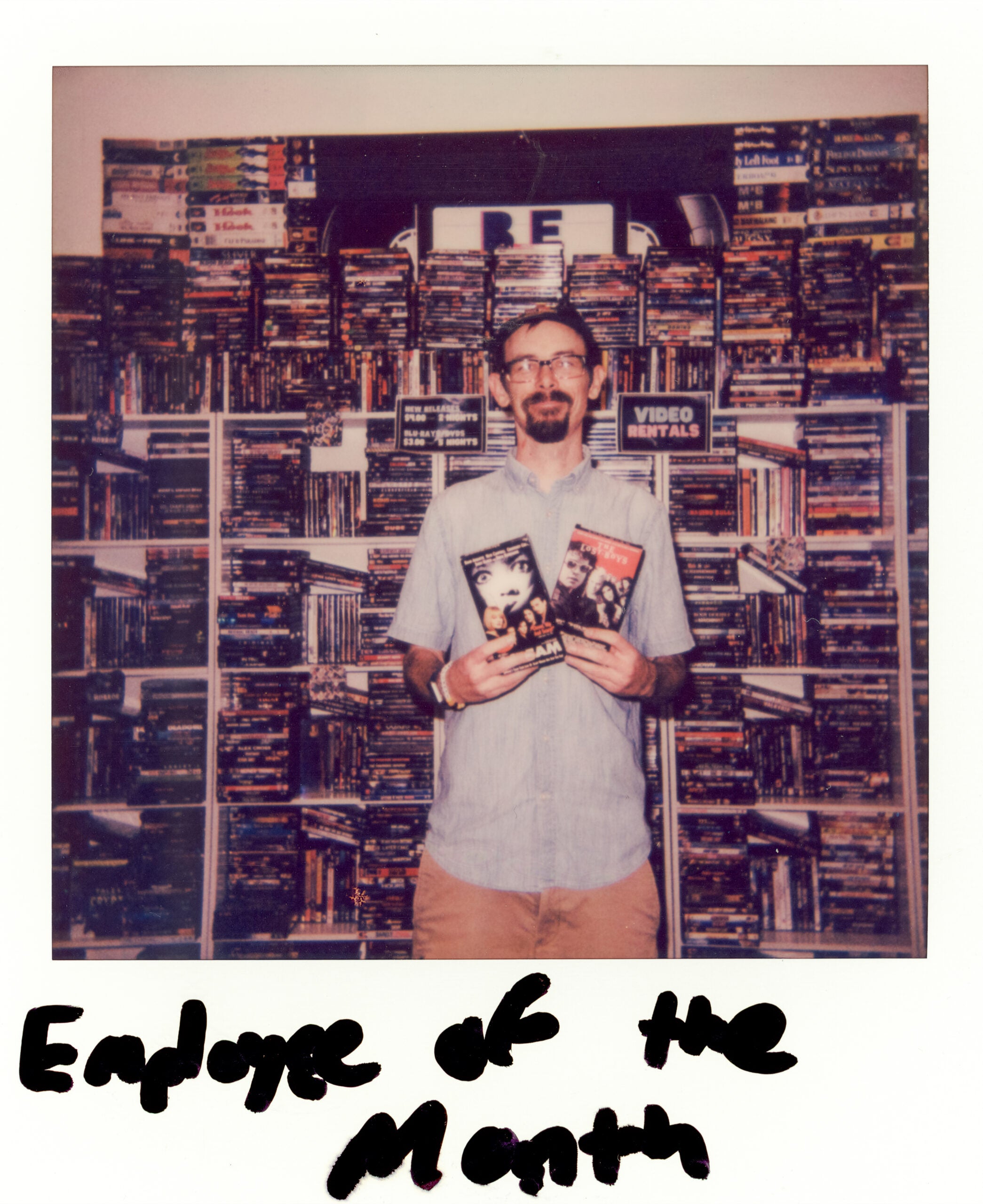 Matthew Renoir, Be Kind founder, stands for a portrait at the shop holding a few of his favorite movies. 