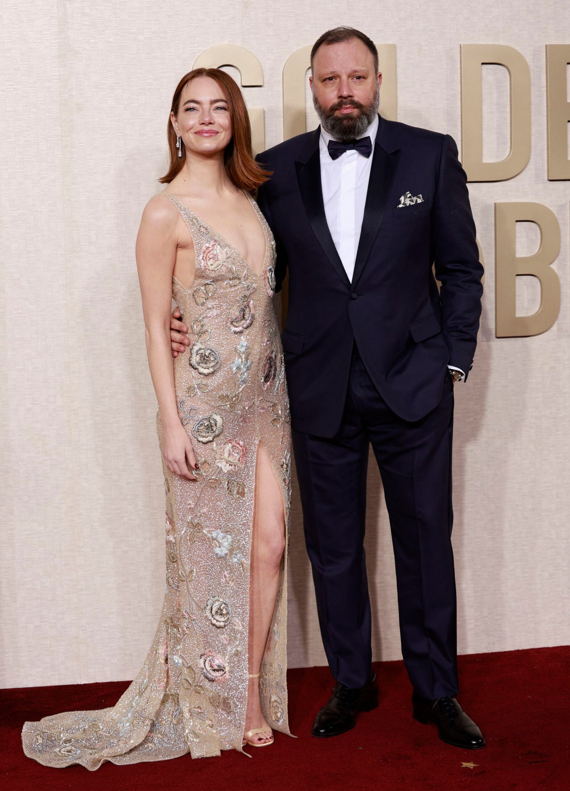 Emma Stone and Yorgos Lanthimos arrive at the 2024 Golden Globes red carpet.