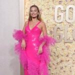 Margot Robbie arrives on the 2024 Golden Globes red carpet.