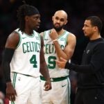 BOSTON, MASSACHUSETTS - JANUARY 10: Boston Celtics head coach Joe Mazzulla at TD Garden speaks with Jrue Holiday #4 and Derrick White #9 on January 10, 2024 in Boston, Massachusetts. The Celtics defeat the Timberwolves 127-120 in overtime.