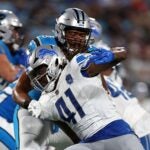 CHARLOTTE, NORTH CAROLINA - AUGUST 25: James Houston #41 of the Detroit Lions bursts off the line of scrimmage against Michael Jordan #73 of the Carolina Panthers during the second quarter of a preseason game at Bank of America Stadium on August 25, 2023 in Charlotte, North Carolina.