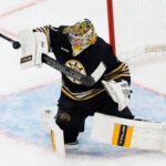 Boston Bruins goaltender Jeremy Swayman (1) makes a save against the New Jersey Devils in the second period at TD Garden.