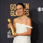 Ali Wong poses in the press room with her Golden Globe award.