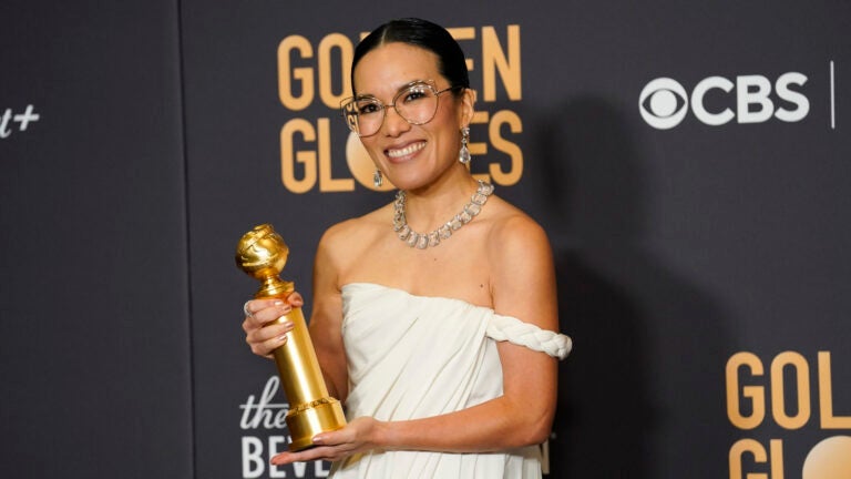 Ali Wong poses in the press room with her Golden Globe award.