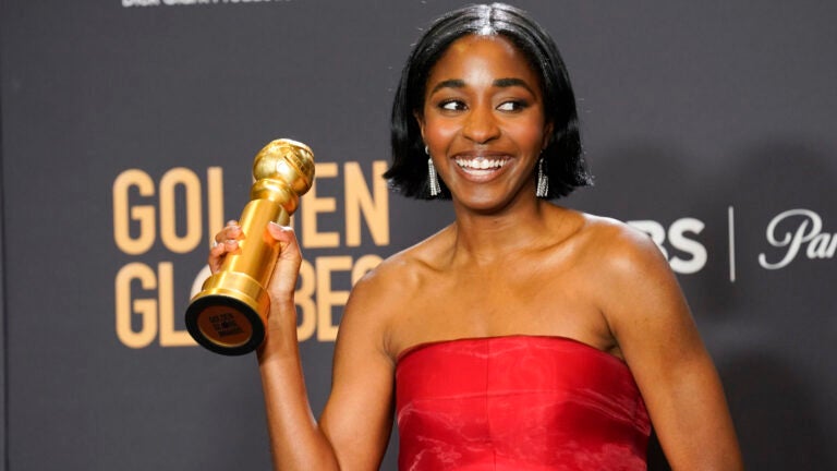 Ayo Edebiri poses in the press room with her Golden Globes award.
