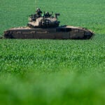 An Israeli tank drives to a position on the border with the Gaza Strip.
