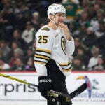 Boston Bruins defenseman Brandon Carlo stands on the ice during the first period of an NHL hockey game against the Minnesota Wild, Saturday, Dec. 23, 2023, in St. Paul, Minn.