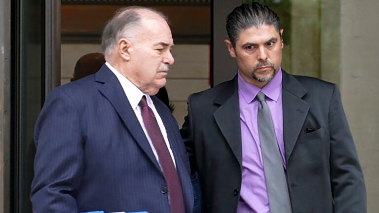 Gino DiGiovanni Jr., right, and his attorney, Martin Minnella, walk out of the federal courthouse in New Haven, Conn.