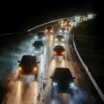 Cars driving on a road while it rains in Massachusetts