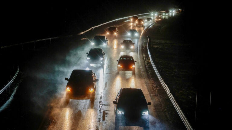 Cars driving on a road while it rains in Massachusetts