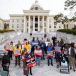 Nearly one hundred protestors gather at the state capitol building in Montgomery, Ala.