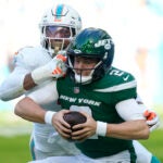New York Jets quarterback Zach Wilson (2) is sacked by Miami Dolphins linebacker Bradley Chubb (2) during the first half of an NFL football game, Sunday, Dec. 17, 2023, in Miami Gardens, Fla.