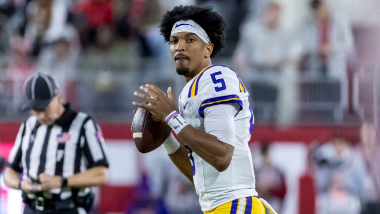 LSU quarterback Jayden Daniels (5) warms up during a timeout in the first half of an NCAA college football game against Alabama, Saturday, Nov. 4, 2023, in Tuscaloosa, Ala.