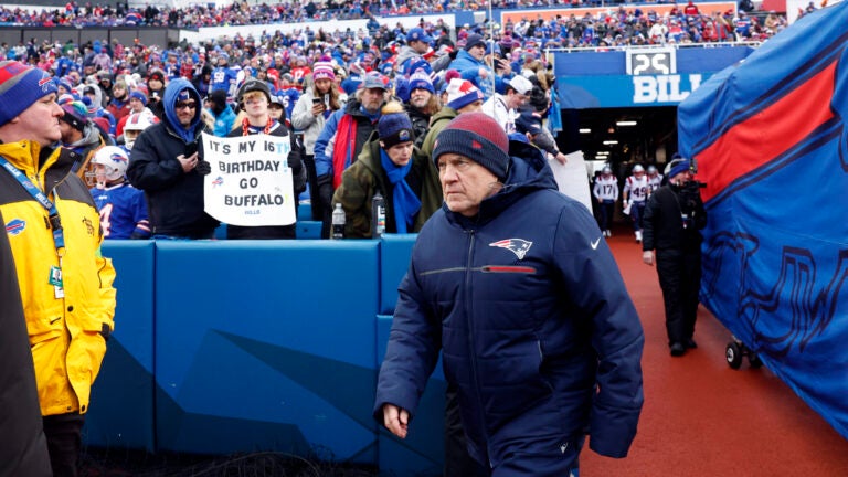 New England Patriots head coach Bill Belichick walks onto the field to face the Buffalo Bills at Highmark Stadium.