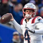 New England Patriots quarterback Bailey Zappe looks to throw a pass during the second half of an NFL football game against the Buffalo Bills in Orchard Park, N.Y., Sunday, Dec. 31, 2023.