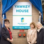 Pine Street Inn and Yawkey Foundation officials stand in front of the newly named Yawkey House, which is a shelter for women who are homeless.