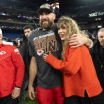 Kansas City Chiefs tight end Travis Kelce walks with Taylor Swift.