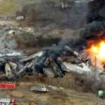 FILE - Portions of a Norfolk Southern freight train that derailed the night before burn in East Palestine, Ohio, Feb. 4, 2023.