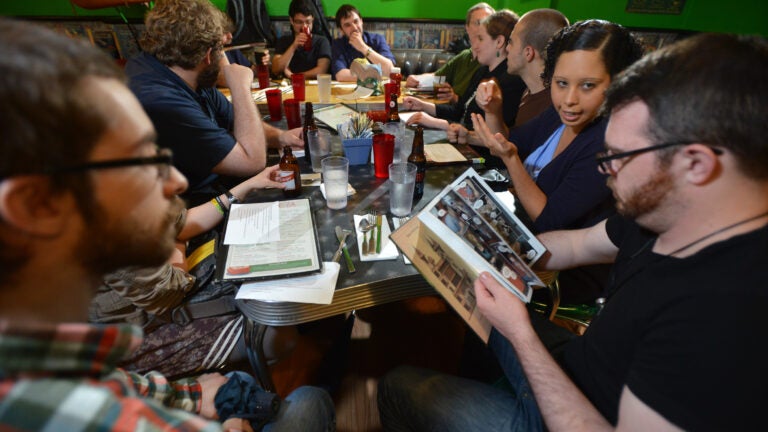 Nick Hansen of Natick, left, Cristina Rivera of Chelsea, second from right, and Jesse Bromley, of Dorchester were among during a comic book reading group meeting at the Friendly Toast in Cambridge.