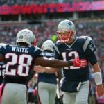 Patriots quarterback Tom Brady (right) celebrates with running back James White (left) after they hooked up for a third quarter touchdown pass, their second of the game. Gillette Stadium Cincinnati Bengals at New England Patriots - 3rd quarter action.