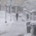 A man walks through the snow near the Worcester Common during a winter storm in Worcester, MA, Jan. 07, 2024.