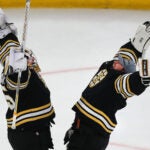 Bruins goalies Boston Bruins goaltender Linus Ullmark (35)(left) and Boston Bruins goaltender Jeremy Swayman (1) congratulate one another at the ned of the Bruins win over the Coyotes, 5-3.