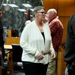 Jennifer Crumbley is escorted away.