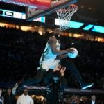 Boston Celtics' Jaylen Brown dunks over Donovan Mitchell during the slam dunk competition at the NBA basketball All-Star weekend, Saturday, Feb. 17, 2024, in Indianapolis.