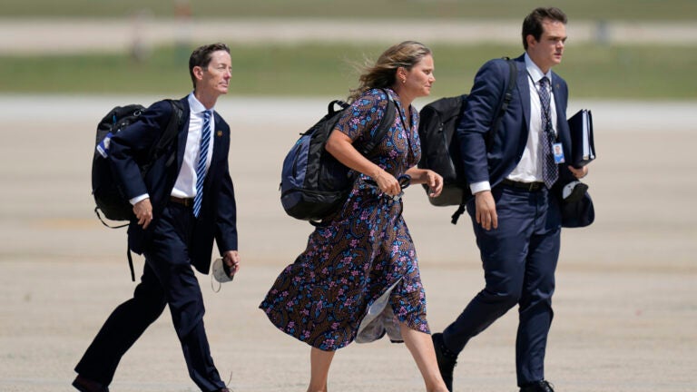 Bruce Reed, Assistant to the President and Deputy Chief of Staff, Annie Tomasini, House senior adviser and director of Oval Office Operations, and Jacob Spreyer board Air Force One.