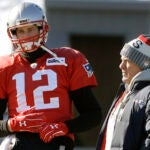 FILE - New England Patriots quarterback Tom Brady, left, stands with head coach Bill Belichick, right, during an NFL football practice, Thursday, Jan. 18, 2018, in Foxborough, Mass. Without Bill Belichick, Tom Brady won his seventh Super Bowl and is on pace to throw a career-high 53 touchdown passes at age 44. Without Brady under center, Belichick is 54-61 over his career, including 8-11 since the future Hall of Fame quarterback left New England for Tampa Bay.