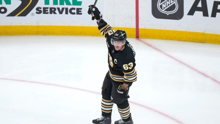 Boston Bruins left wing Brad Marchand celebrates his goal against the Vancouver Canucks during the first period of an NHL hockey game Thursday, Feb. 8, 2024, in Boston.