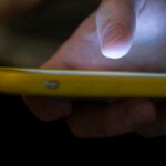 A man uses a cell phone.