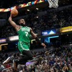 Boston Celtics guard Jaylen Brown (7) goes up to score on a breakaway dunk against the Indiana Pacers during the second half of an NBA basketball game in Indianapolis, Saturday, Jan. 6, 2024.