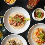 Plates of tacos and queso dip from La Ventana