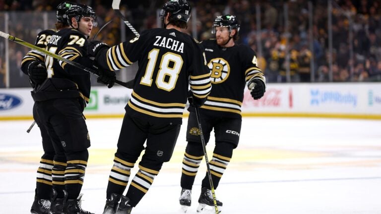 BOSTON, MASSACHUSETTS - JANUARY 18: Jake DeBrusk #74 of the Boston Bruins celebrates with Pavel Zacha #18, Parker Wotherspoon #29 and Matt Grzelcyk #48 after scoring against the Colorado Avalanche during the first period at TD Garden on January 18, 2024 in Boston, Massachusetts.